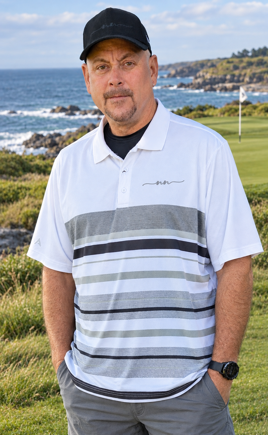 Man wearing Antigua Drive Men's Performance Polo on a coastal golf course