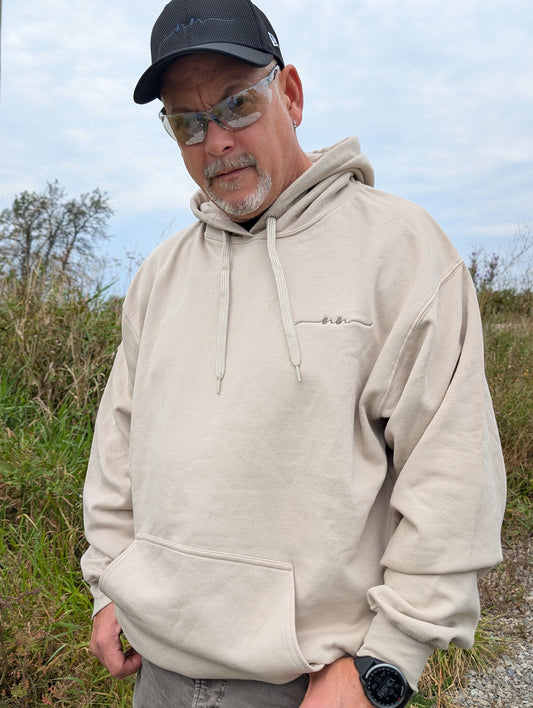 The Coastal Hoodie in Dunedrift — front view showing tonal drawstrings and chest embroidery